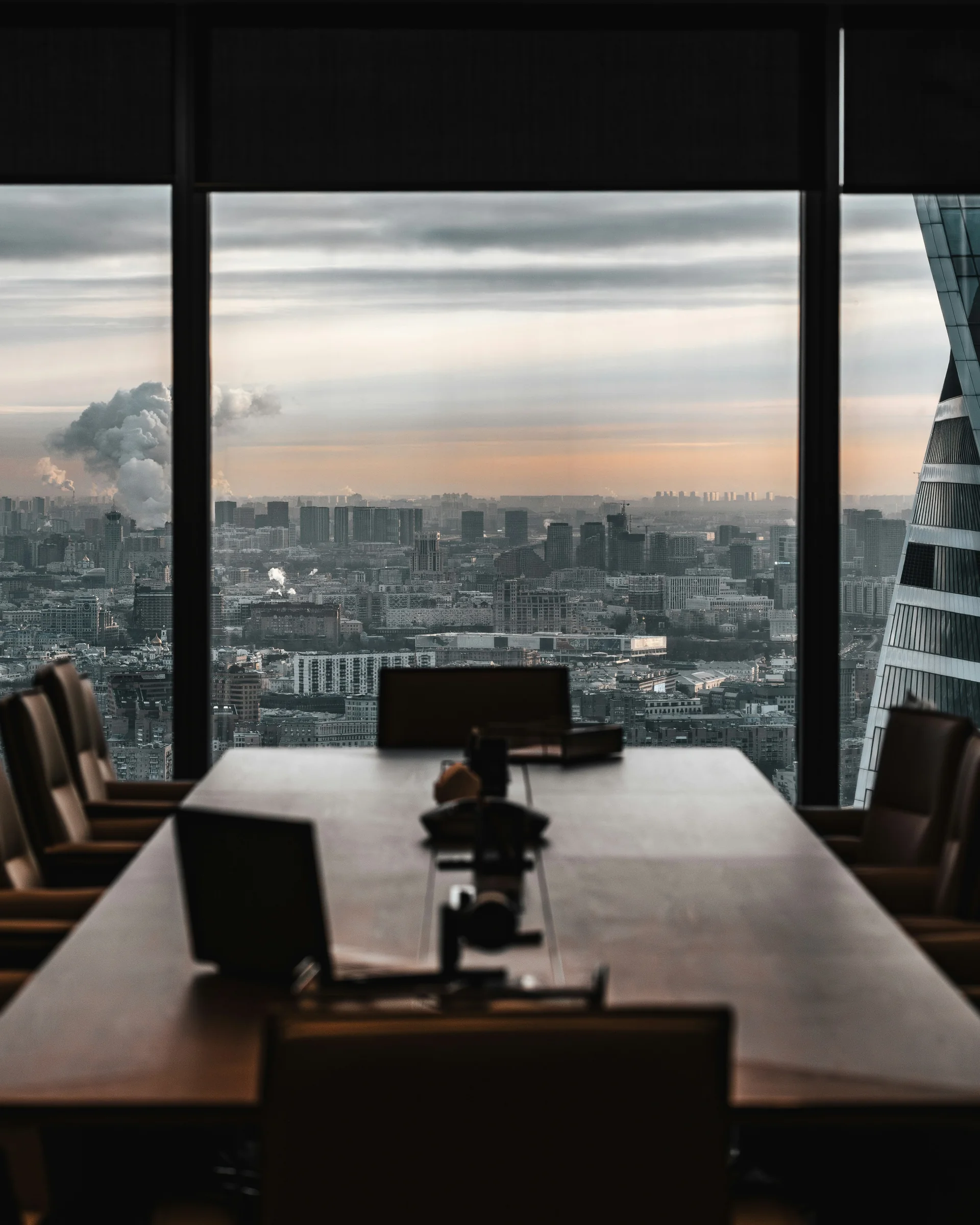 Private client boardroom with panoramic city view at sunset — CM2 advisory services